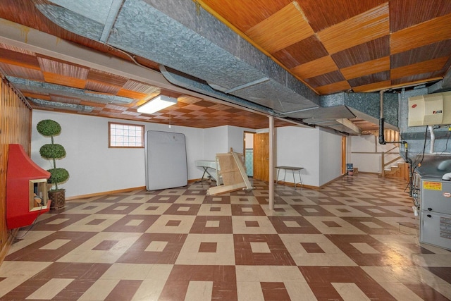 below grade area featuring tile patterned floors, baseboards, and stairs