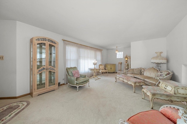 carpeted living room featuring baseboards