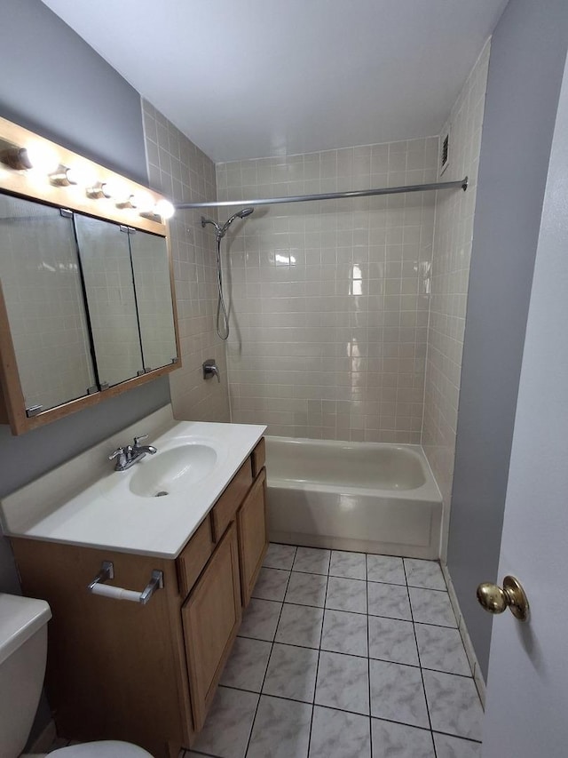 full bath with shower / bathing tub combination, toilet, vanity, and tile patterned flooring