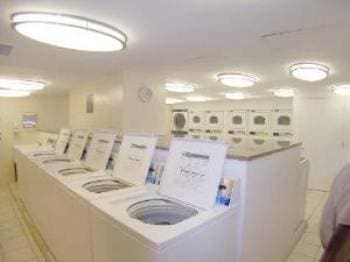 shared laundry area with light tile patterned floors and washer and clothes dryer