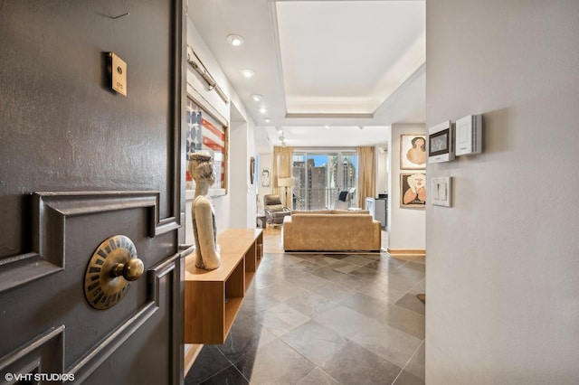 hall featuring a raised ceiling and a view of city