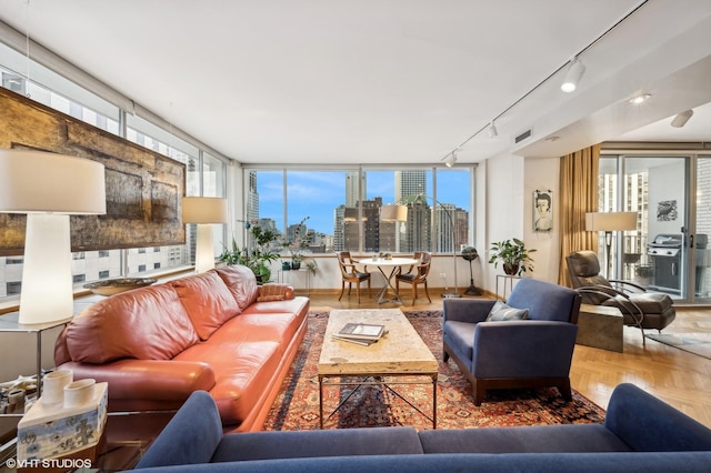 living area featuring visible vents, a city view, and rail lighting