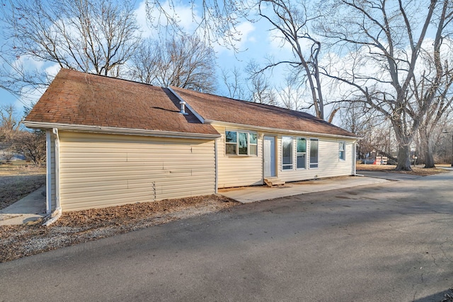 exterior space with a shingled roof