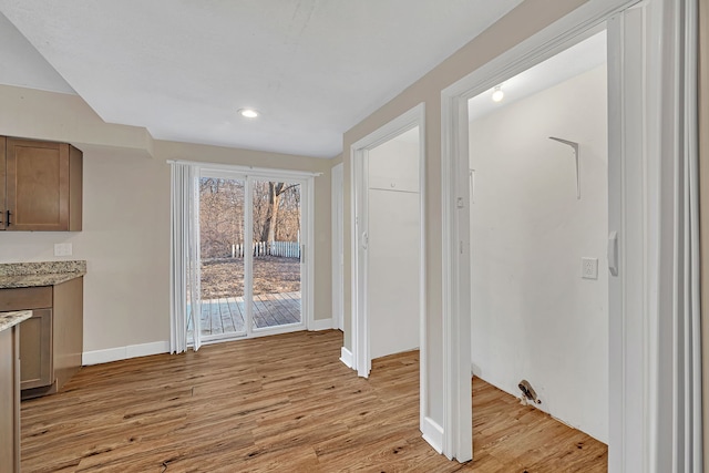 interior space featuring recessed lighting, light wood-style floors, and baseboards