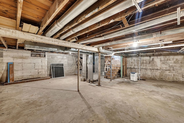 unfinished basement featuring heating unit