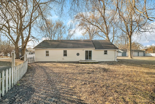 rear view of house with a deck and fence