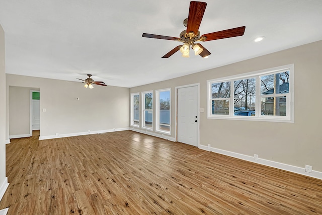 unfurnished living room featuring ceiling fan, baseboards, wood finished floors, and recessed lighting