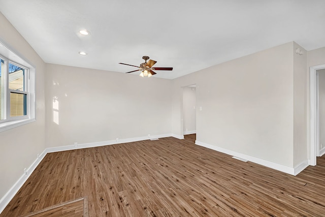 unfurnished room featuring recessed lighting, ceiling fan, baseboards, and wood finished floors