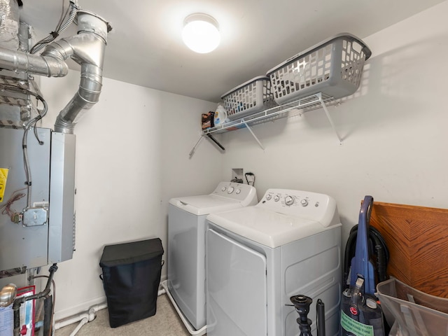 laundry area with laundry area, washer and dryer, carpet, and baseboards