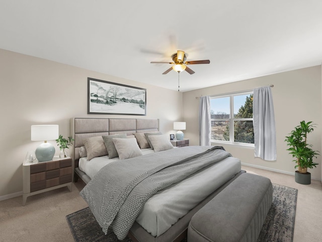 bedroom featuring a ceiling fan, baseboards, and light carpet