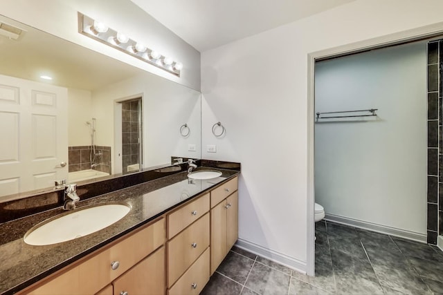 bathroom with double vanity, visible vents, toilet, and a sink