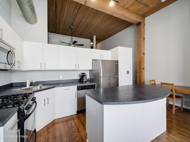 2333 W Saint Paul Ave Unit 331, Chicago, IL 60647 - kitchen with stainless steel appliances, dark countertops, wooden ceiling, dark wood finished floors, and white cabinets