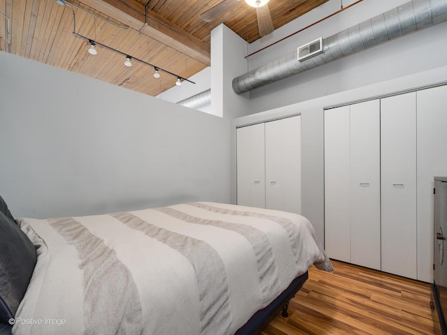 2333 W Saint Paul Ave Unit 331, Chicago, IL 60647 - bedroom with two closets, a wood ceiling with exposed beams, wood finished floors, and a towering ceiling