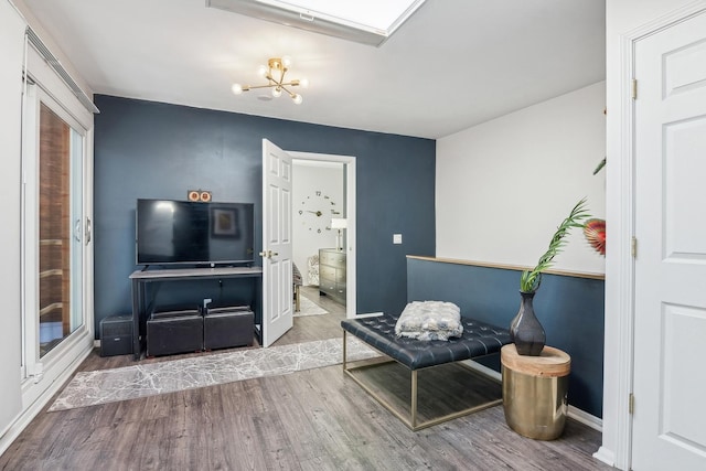 living area with an inviting chandelier and wood finished floors