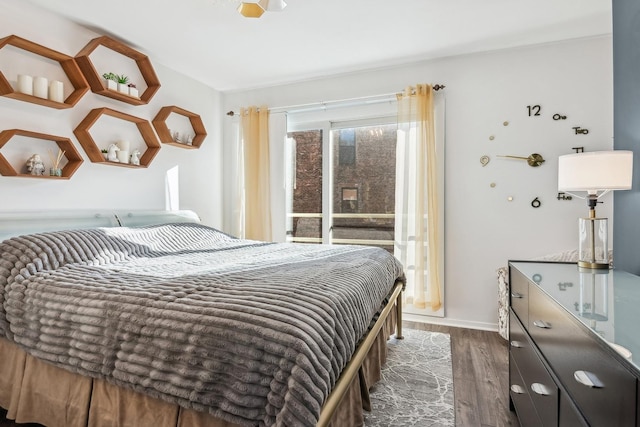 bedroom with baseboards and wood finished floors