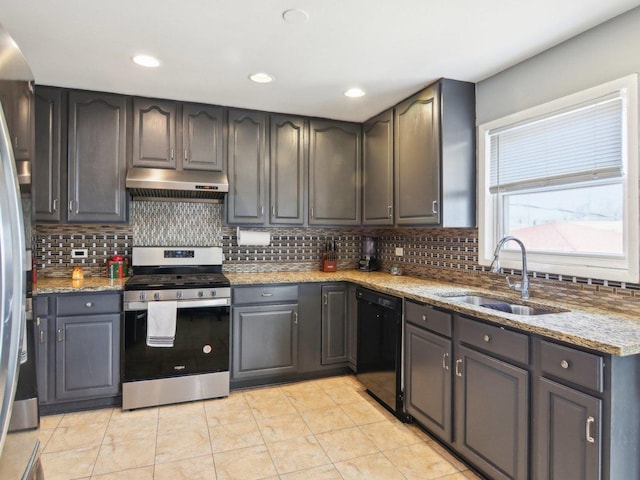 kitchen with tasteful backsplash, under cabinet range hood, stainless steel range with gas stovetop, dishwasher, and a sink