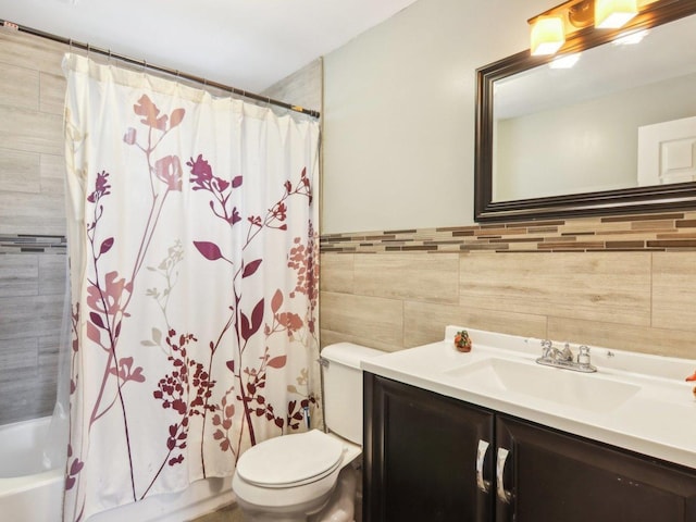 bathroom featuring toilet, tile walls, vanity, and shower / bath combo