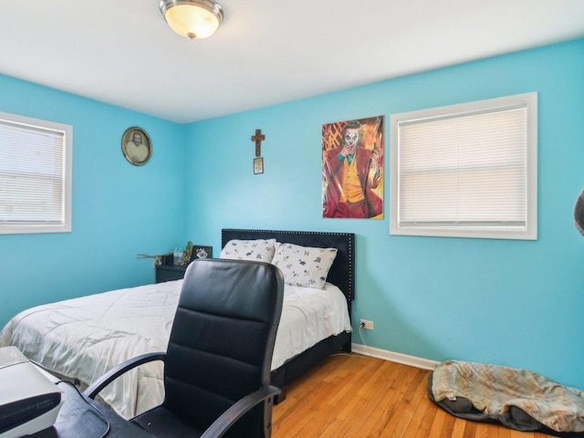 bedroom with baseboards and hardwood / wood-style floors