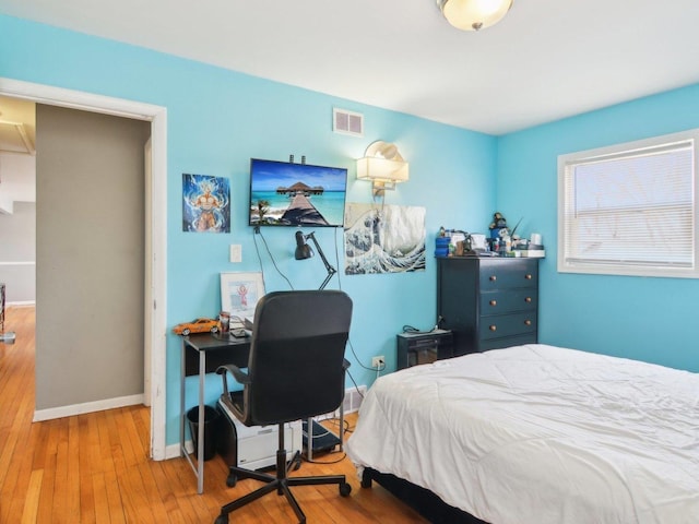 bedroom with visible vents, baseboards, and wood-type flooring