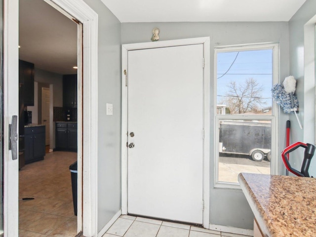 foyer with light tile patterned floors and plenty of natural light