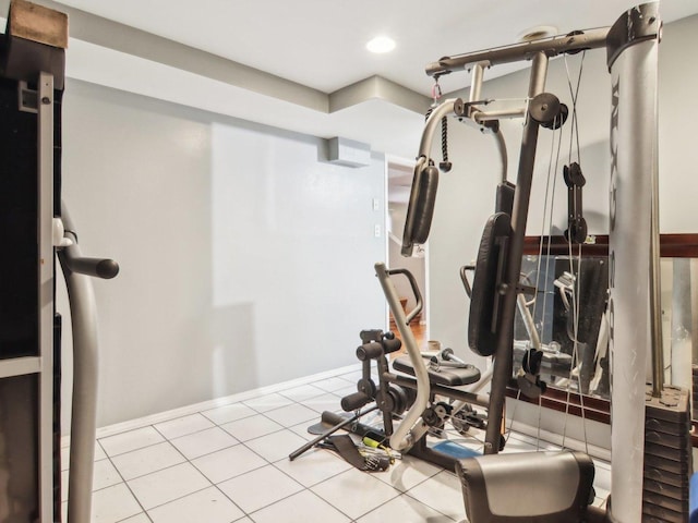 exercise room featuring tile patterned floors, baseboards, and recessed lighting