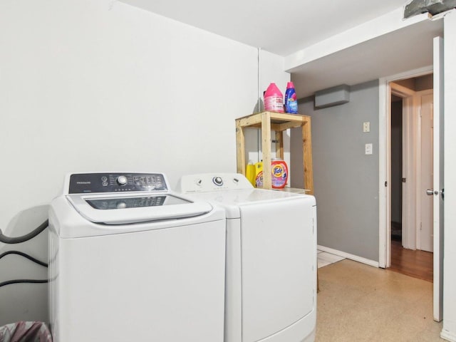 laundry room featuring baseboards, laundry area, and washing machine and clothes dryer