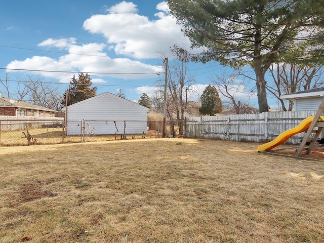 view of yard featuring a fenced backyard and a playground