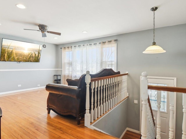 interior space featuring recessed lighting, baseboards, an upstairs landing, and hardwood / wood-style floors