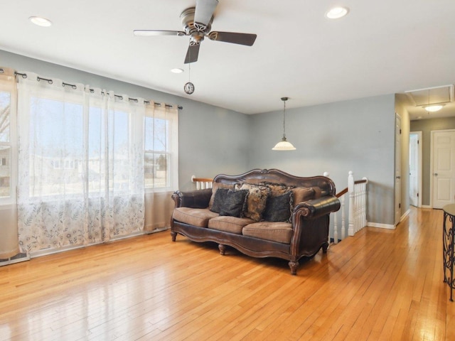 living area with recessed lighting, attic access, and light wood-type flooring