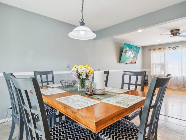 dining area with light tile patterned floors and a ceiling fan