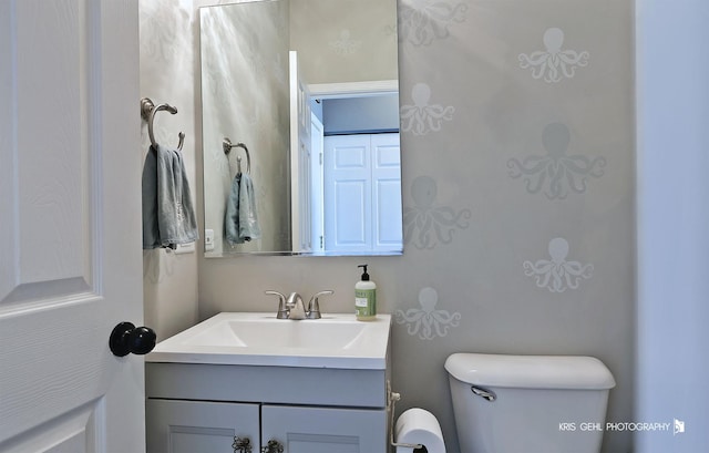 bathroom with toilet and vanity