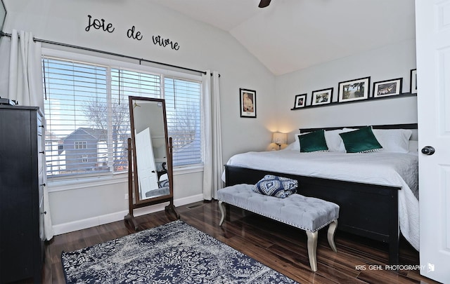 bedroom with baseboards, a ceiling fan, lofted ceiling, and wood finished floors