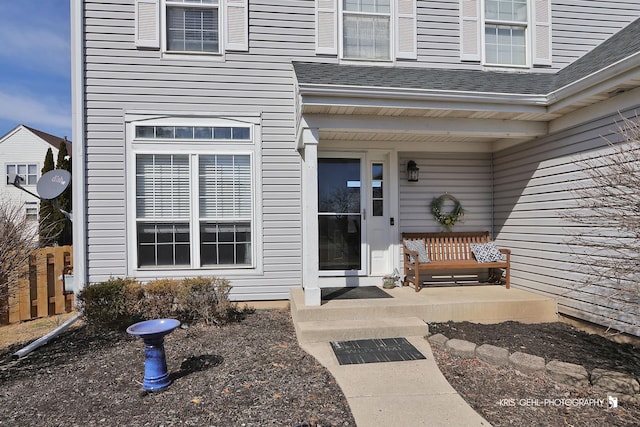 property entrance featuring roof with shingles