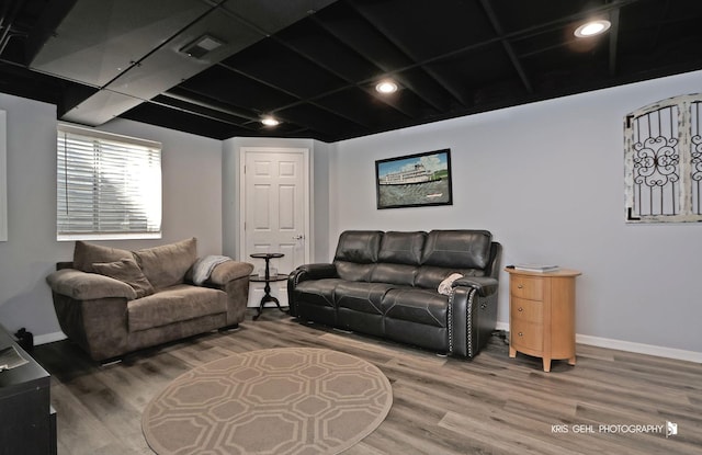 living area with visible vents, recessed lighting, baseboards, and wood finished floors