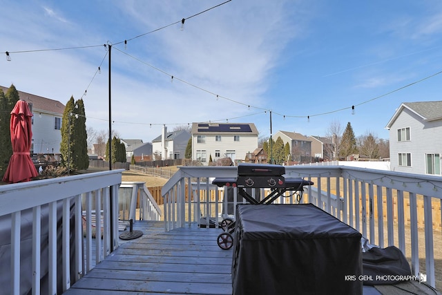 wooden terrace featuring a residential view, area for grilling, and fence