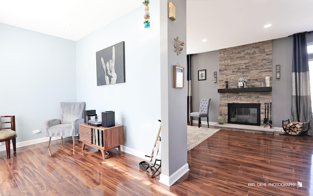 sitting room with recessed lighting, baseboards, wood finished floors, and a fireplace