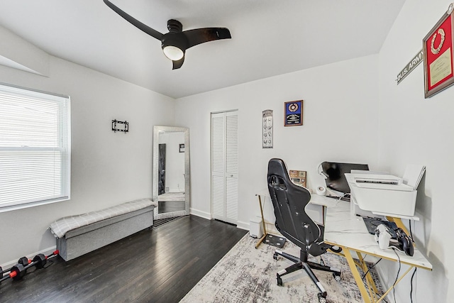 office space featuring baseboards, ceiling fan, and wood finished floors