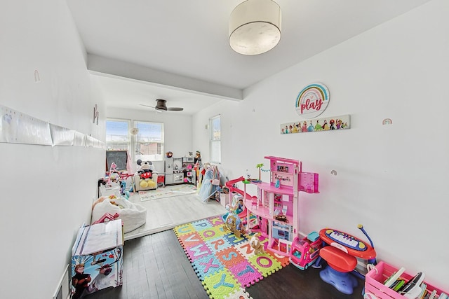 recreation room with wood finished floors and a ceiling fan