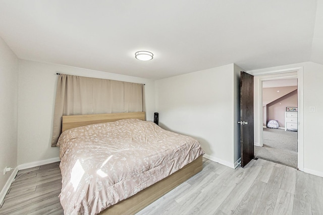 bedroom featuring baseboards and light wood-type flooring