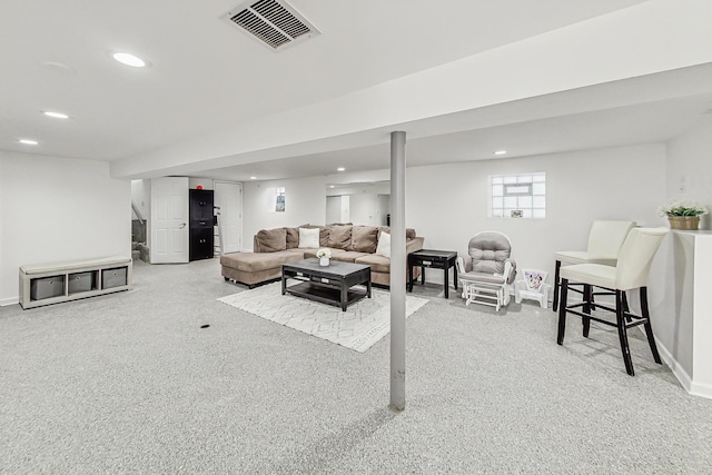 carpeted living room featuring recessed lighting, visible vents, and baseboards