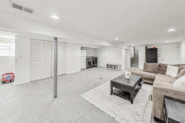 living room with stairway, recessed lighting, separate washer and dryer, and visible vents