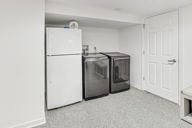 laundry room with baseboards, independent washer and dryer, and laundry area