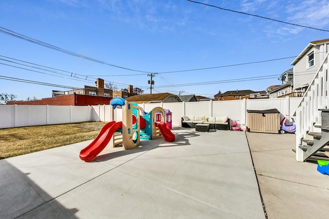 view of play area featuring an outdoor living space, a patio area, and a fenced backyard