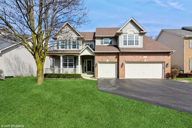 view of front of house featuring a front yard, a porch, an attached garage, aphalt driveway, and brick siding