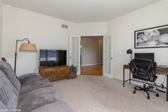 living area with visible vents, french doors, baseboards, and carpet floors