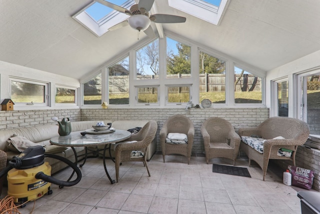 sunroom featuring lofted ceiling with skylight and a ceiling fan