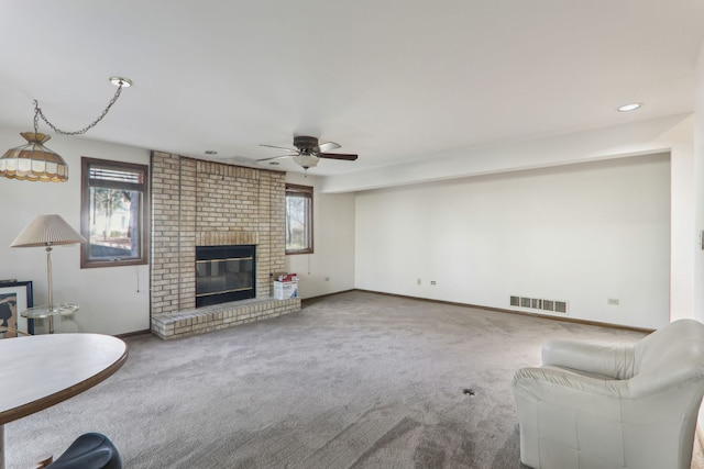 unfurnished living room featuring visible vents, carpet floors, baseboards, and a fireplace