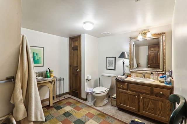 bathroom featuring visible vents, toilet, and vanity