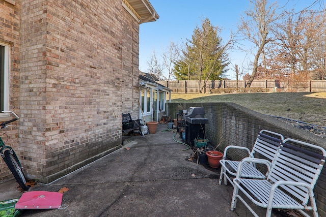 view of patio featuring a grill and a fenced backyard