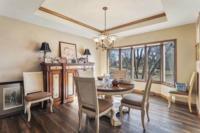 dining room with dark wood-style floors, a chandelier, baseboards, and a tray ceiling